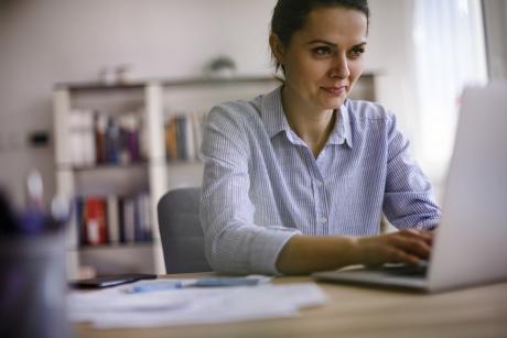 woman using her computer for a web seminar