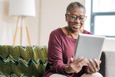 woman smiling at ipad