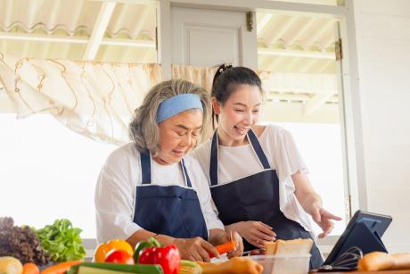 Mother and daughter prepare meal together
