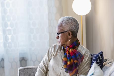 Older black woman looking to the side, contemplative
