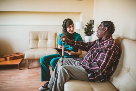 Healthcare worker talking to older man