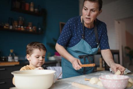 A woman and her grandson baking at home