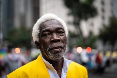 older Black man on city street looking at camera