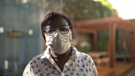 Portrait of a older Black woman using face mask