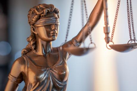 Statue of Justice with scales in lawyer office. 
