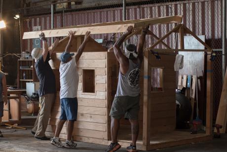  Men work shoulder to shoulder on a project in the Honolulu Men's Shed. 
