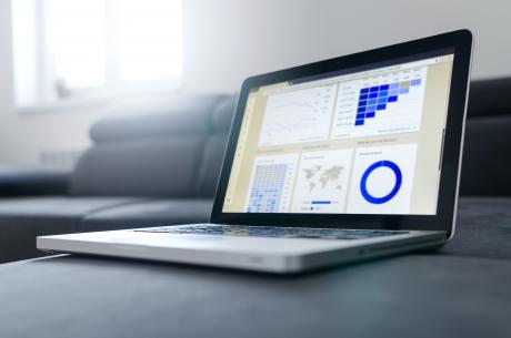 picture of a laptop with various graphs on the screen