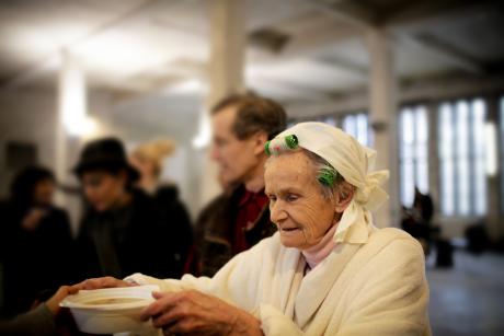 Older woman gets a bowl of soup
