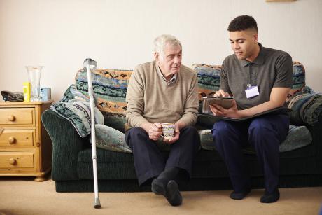 Care manager talking to older man