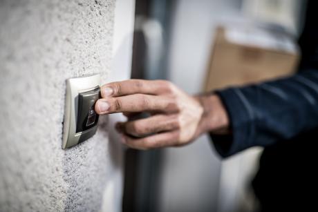 hand ringing doorbell