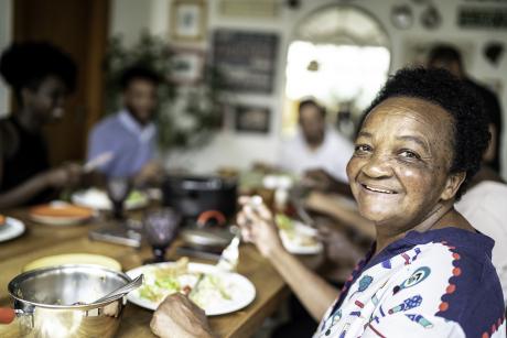 Older woman eating with her family