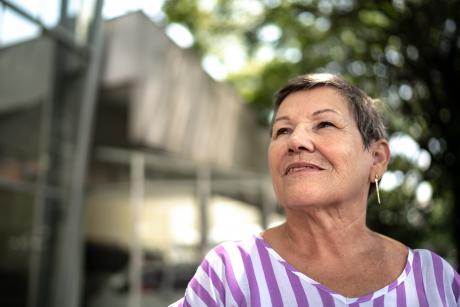 Older woman looking away, outdoors