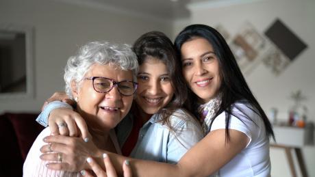 Three generations of women smiling at the camera