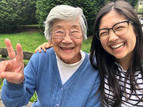 Granddaughter and grandmother smiling/laughing at the camera