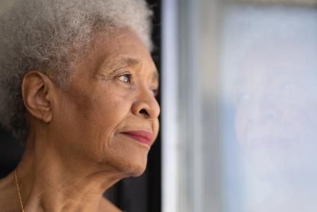 Older woman looking out window