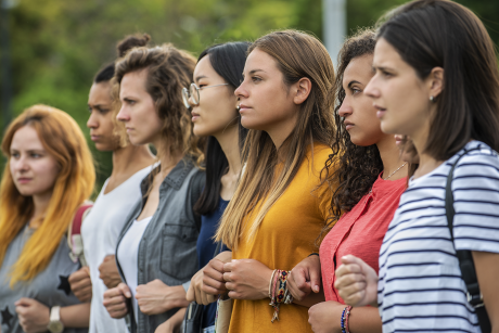 Line of diverse women joined and protesting