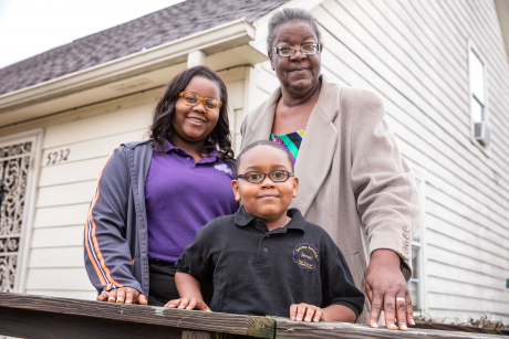 Carrie Hawkins stands on her deck with her grands.