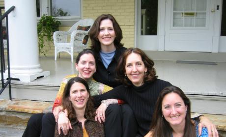 Photo of five women who are sisters sitting on the front steps of a house