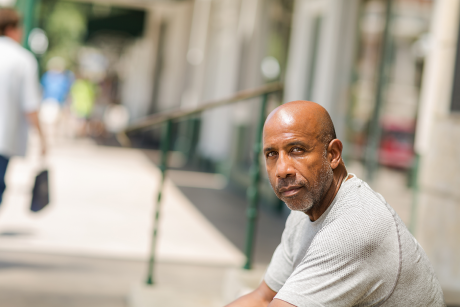 Black man, over 50 looking straight into camera