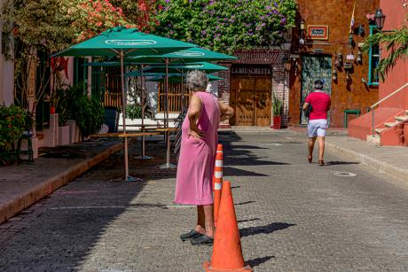 Woman in pink dress seeking cooler temps