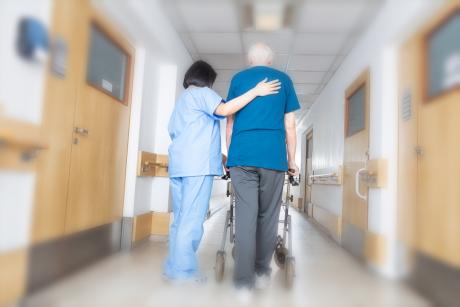 Walking down hall with assistance in nursing home