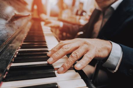 Older man plays piano