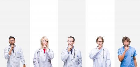 Doctors standing in line shushing