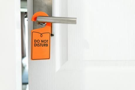 Door cracked open, do not disturb sign