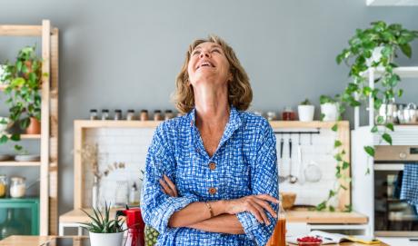 Older woman in blue shirt, exalting