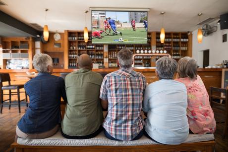 Watching TV with friends in a bar